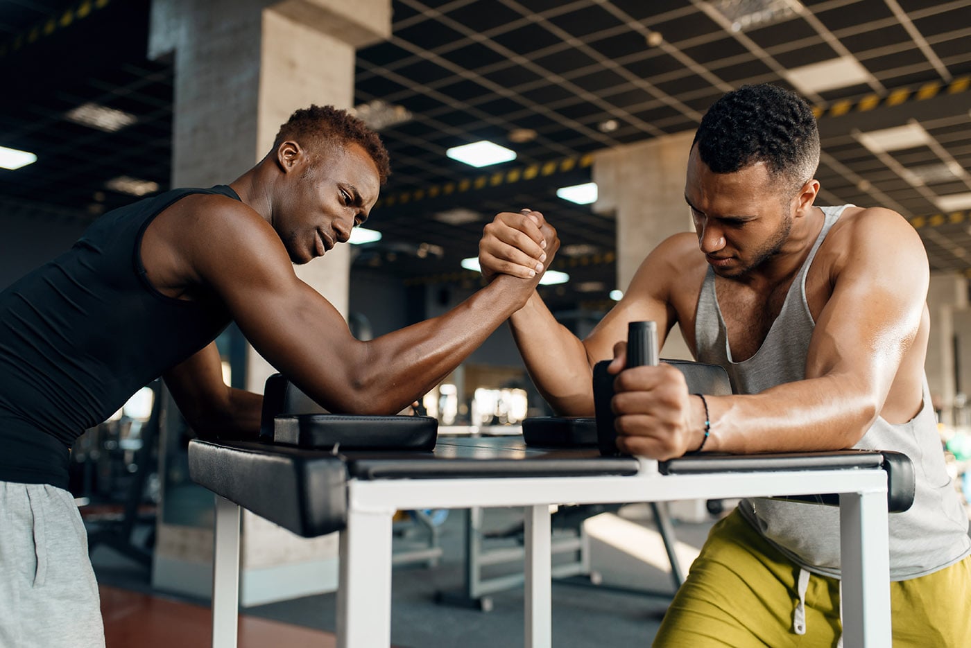 two-men-fighting-arm-wrestling-training-in-gym-CQ468DL-min.jpg